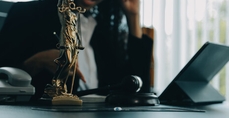 Judge gavel with Justice lawyers having team meeting at law firm background. Concepts of Law and Legal services.