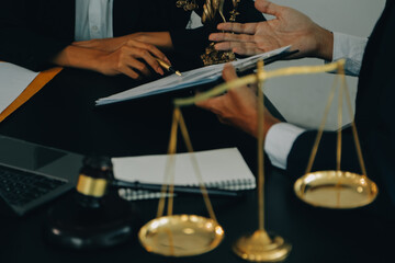 Judge gavel with Justice lawyers having team meeting at law firm background. Concepts of Law and Legal services.