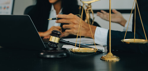 Judge gavel with Justice lawyers having team meeting at law firm background. Concepts of Law and Legal services.