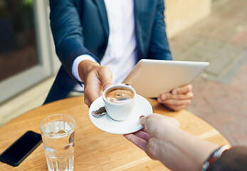 Waiter, serving and hands with coffee on table at cafe with customer reading tablet for internet,...