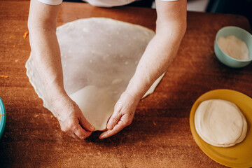Obraz na płótnie Canvas Person preparing pastries from dough with pumpkin