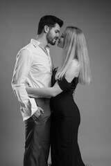 Attractive young couple posing in studio black and white photo