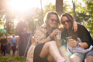 Beer, laughing and woman friends in forest together with audience or crowd at event, festival or party. Smile, funny and young people having fun in nature woods for social gathering and celebration