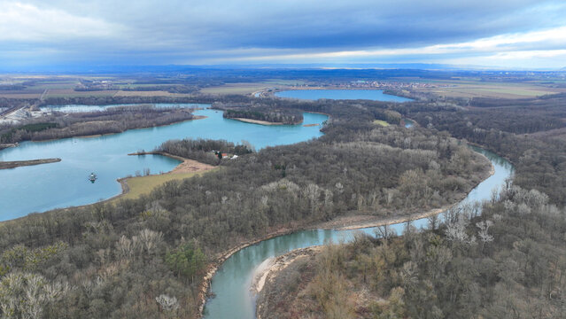 River floodplain winter delta Zastudanci meander drone aerial inland video shot in sandy sand alluvium freezing cold national nature reserve, benches forest and lowlands wetland swamp, view flying fly