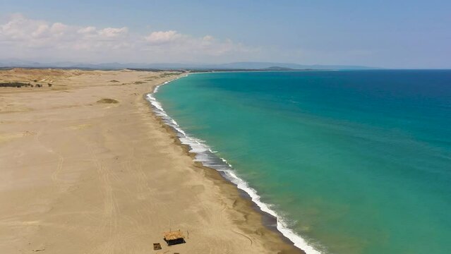 Top view of sandy beach and blue ocean. Paoay Sand Dunes, Ilocos Norte, Philippines.