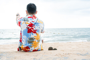 Young man admiring the sea and looks out to sea from coastal. Peaceful place to relax and meditate....