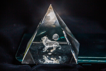 Volumetric 3D lion inside a transparent triangle on a black background