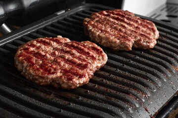 Beef cutlet for burger on grid grill