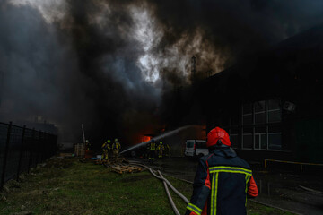 Firefighters extinguish a burning building at a site of a russian missile strike in Kyiv, Ukraine January 2, 2024