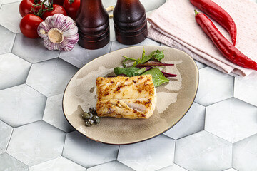 Roasted cod fish steak with salad