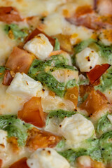pizza using a large number of different ingredients close-up