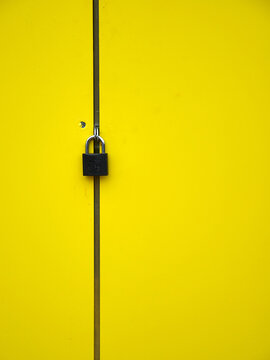 yellow doors closed with a padlock