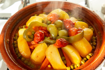 Moroccan cuisine tajine vegetables with meat cooked in typical North African terracotta pan - 732341856