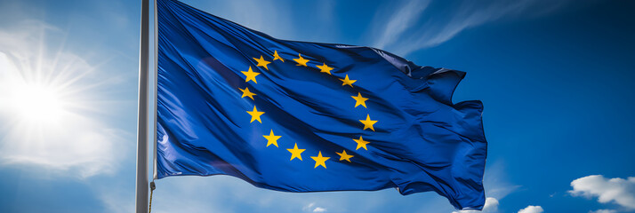 Obraz na płótnie Canvas Radiant European Union Flag Against Clear Blue Sky: A Symbol of Unity and Strength