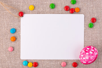 Easter composition with eggs on a linen surface. White card for an inscription.