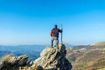 A man on the top of Mount Ernio or Hernio in Gipuzkoa at sunset, Basque Country
