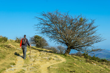 Fototapeta premium Trekking along the trail up to Mount Ernio or Hernio in Gipuzkoa at sunset, Basque Country
