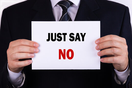 Businessman holding a card with text just say no
