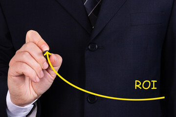 Businessman draw growing line symbolize growing ROI Return on Investment