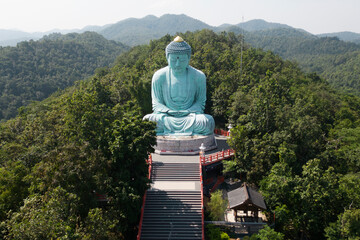Outdoor great Buddha Daibutsu or Amitabhe Buddha at Wat Pra That Doi Pra Chan. It is a green rust Buddha statue made from a mixture of copper that was used to create it. Lacated at Lampang, Thailand.