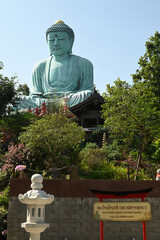 Outdoor great Buddha Daibutsu or Amitabhe Buddha at Wat Pra That Doi Pra Chan. It is a green rust...