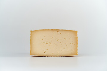 
Piece of cured manchego cheese with white background