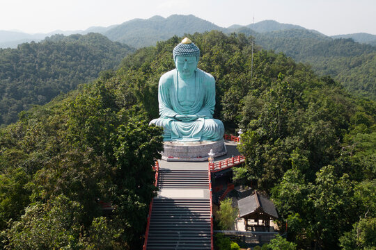 Outdoor great Buddha Daibutsu or Amitabhe Buddha at Wat Pra That Doi Pra Chan. It is a green rust Buddha statue made from a mixture of copper that was used to create it. Lacated at Lampang, Thailand.