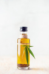 Oil and  hemp leaves and on a wooden background. Cannabis oil in a bottle. Natural eco product