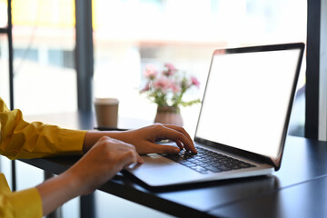 Woman hands typing on laptop keyboard, checking email or searching information