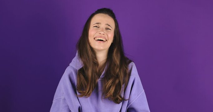 Fake, crying woman face in studio with hands gesture for sad, bullying or gesture on purple background. Tears, face and female joke, cry and sign on mockup with unhappy boo emoji or fist of loser.