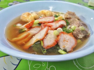 Thai food, Thai street food, noodles with pork and dumplings with pork.