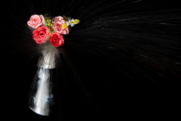 Bouquet of flowers in the vase on a black background