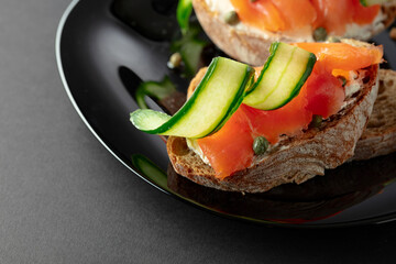 Sandwiches with smoked trout, cream cheese, fresh cucumber, and capers.