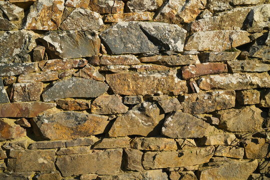 Old stone wall made of rocks close up