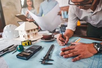 architecture, architect, construction, engineer, project, design, blueprint, house, model, plan. engineer use pencil and ruler to measure architects on the desk with a blueprint in the office.