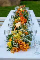 Beautiful flowers decorated on the table.Tables set for an event party or 
wedding reception luxury elegant table setting dinner in a restaurant
