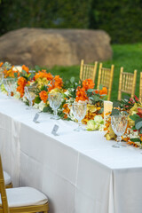 Beautiful flowers decorated on the table.Tables set for an event party or 
wedding reception luxury elegant table setting dinner in a restaurant