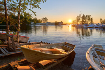 Naklejka na ściany i meble Boats at sunset and lake