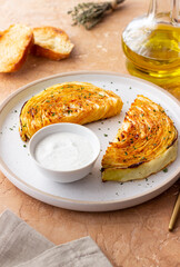 Cabbage steaks with white sauce. Healthy eating. Vegetarian food.
