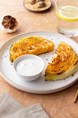 Cabbage steaks with white sauce. Healthy eating. Vegetarian food.