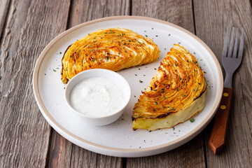 Cabbage steaks with white sauce. Healthy eating. Vegetarian food.