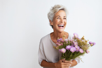 Joyful senior woman holding bouquet of fresh flowers. Happiness and aging gracefully.