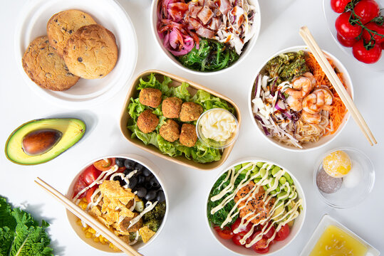 Asian food from above on white table poke bawl falafel, cockies , mochi with meat, fish and vegetable ingredients 