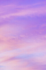Sky with soft and fluffy pastel orange pink and blue colored clouds. Sunset background. Nature. sunrise. Vertical