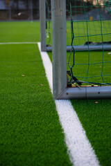 White markings and goal post of an artificial turf football field.