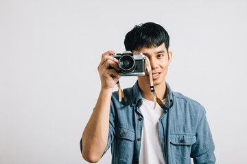 Excitement fills the air as a young man poses for a vintage camera, ready to be photographed. Studio shot isolated on white background. The result is a picture that defines glamour