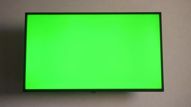 TV set with green screen mock up display in hotel room.