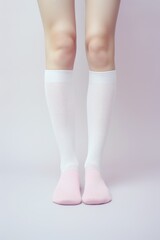 A picture of a person wearing white socks and pink socks. Can be used to showcase different sock styles or as a fashion accessory image