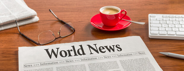 A newspaper on a wooden desk - World news