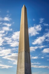 A picture of a very tall monument with a clock on top. This image can be used to represent landmarks, history, time, and architecture